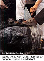 Feet on Sadaam's statue in Najaf, Iraq, April 2003