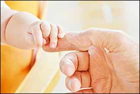 Baby's hand on daddy's finger