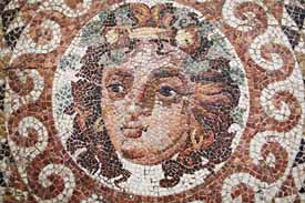 The head of Dionysos, detail from a beautifully preserved mosaic floor from a Roman villa (2nd century A.D). Dionysos is  the Greek god of wine and madness, vegetation, and the theatre, and was the focus of various mystery cults.  Archaeological Museum of Ancient Corinth.