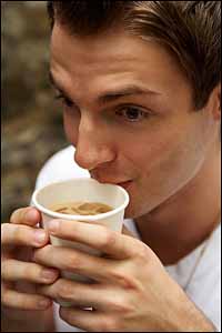 Young man drinking iced coffee