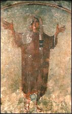 Orante figure from the Catacomb of Priscilla, Cubicle of the Velata, Rome (second half of the third century). This pose of arms lifted in prayer is found in thousands of figures in the catacombs, representing a soul at peace in paradise.