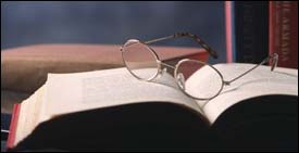 Bible study open book with glasses